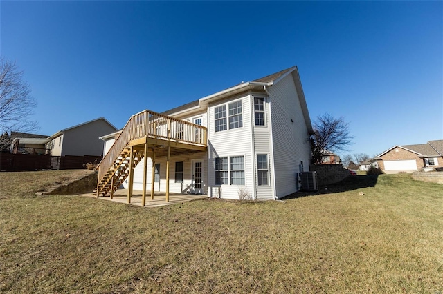 back of house featuring a wooden deck, a patio, central AC unit, and a lawn