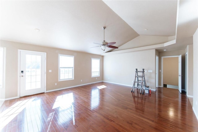 unfurnished living room featuring dark hardwood / wood-style flooring, lofted ceiling, and a healthy amount of sunlight