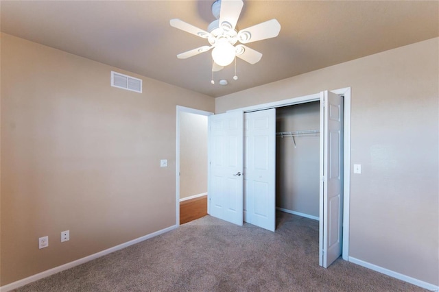 unfurnished bedroom with carpet flooring, ceiling fan, and a closet