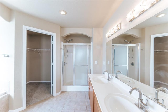 bathroom with vanity, tile patterned flooring, and plus walk in shower