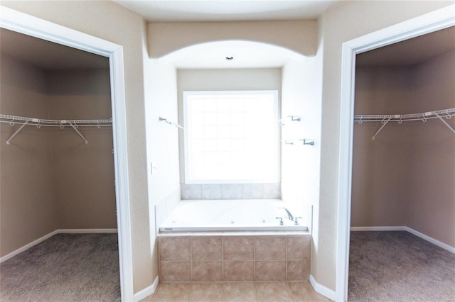 bathroom featuring a relaxing tiled tub