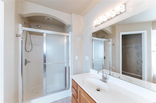 bathroom with vanity, tile patterned flooring, and a shower with door