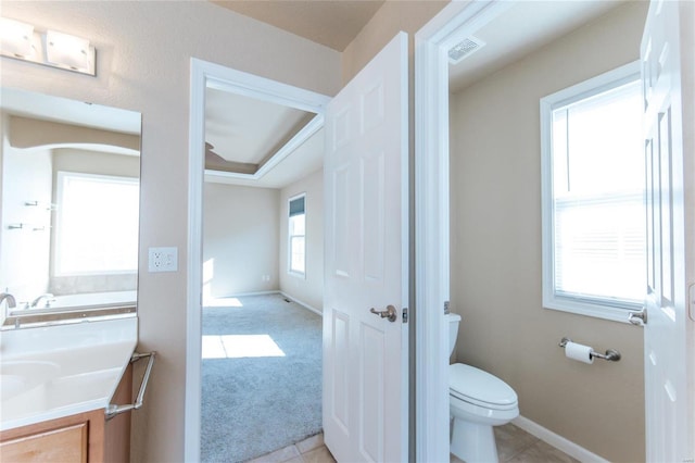 bathroom with tile patterned flooring, vanity, and toilet