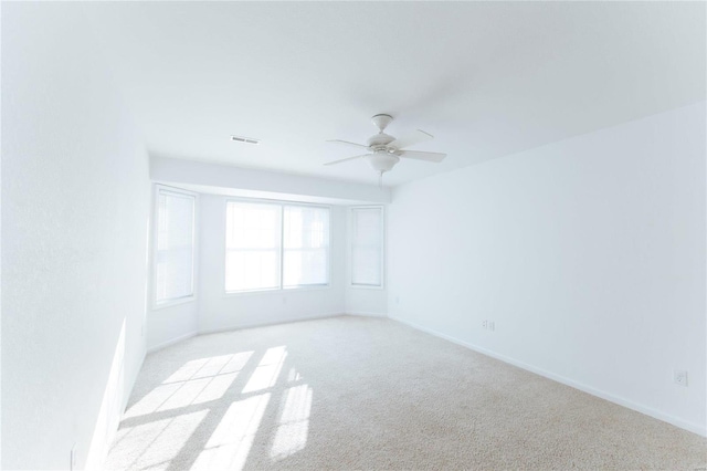 carpeted empty room featuring ceiling fan