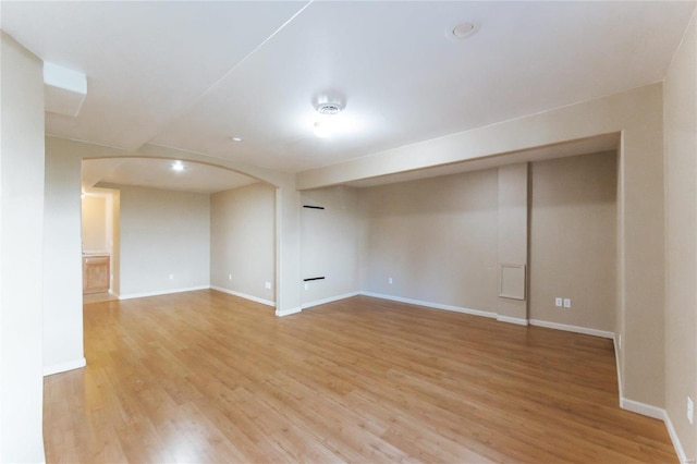 basement with light hardwood / wood-style floors