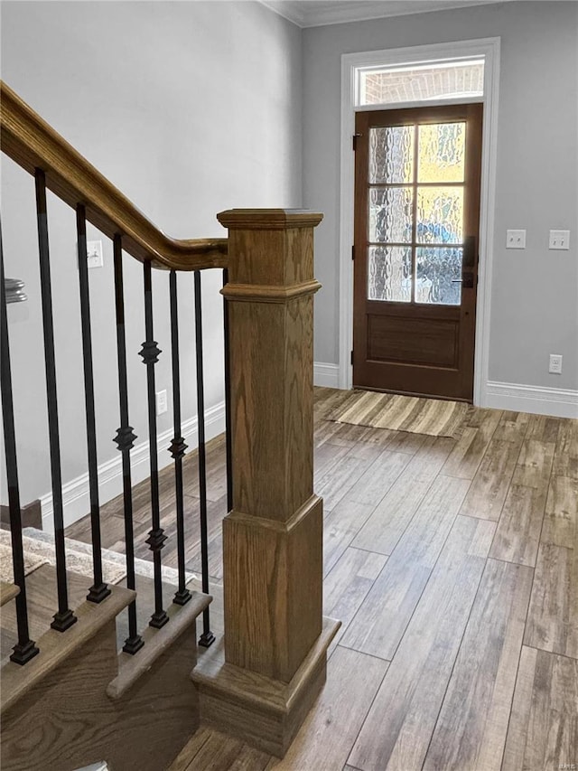 interior space with crown molding and light hardwood / wood-style floors