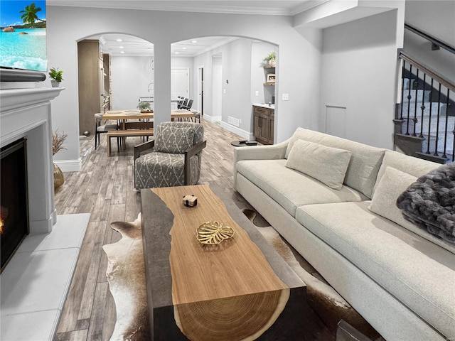 living room with hardwood / wood-style flooring and ornamental molding