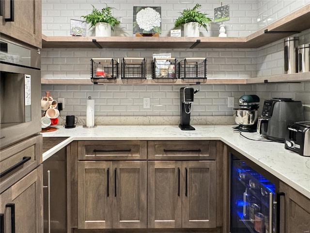 interior space featuring tasteful backsplash, wall oven, wine cooler, and light stone counters