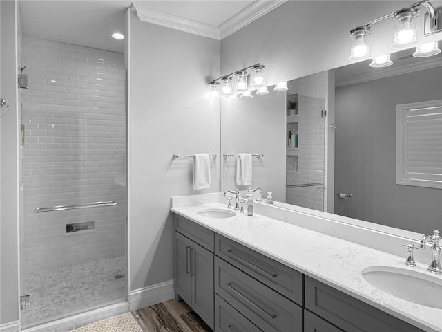 bathroom featuring hardwood / wood-style flooring, a shower with door, crown molding, and vanity