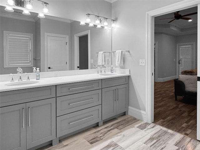 bathroom featuring ceiling fan with notable chandelier, vanity, and crown molding