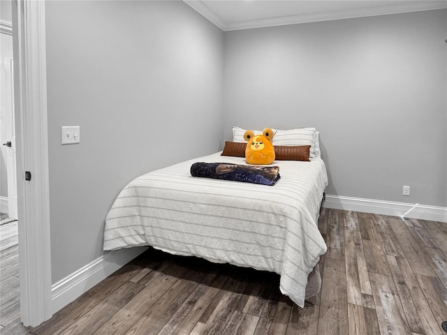 bedroom with crown molding and hardwood / wood-style floors