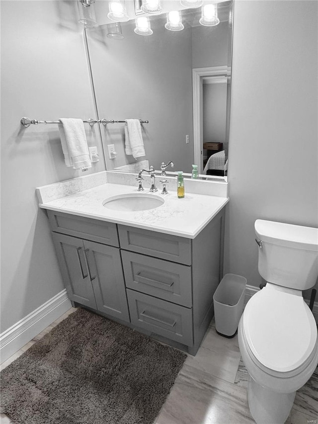 bathroom featuring toilet and vanity