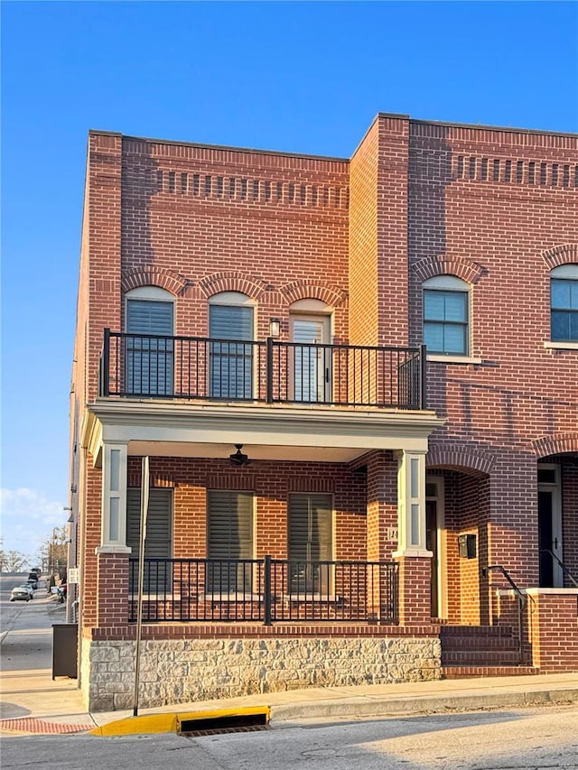 view of front facade featuring a balcony and covered porch