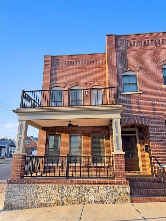 view of front of house with a porch, a balcony, and ceiling fan