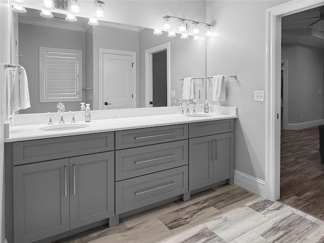 bathroom featuring vanity, hardwood / wood-style floors, and crown molding