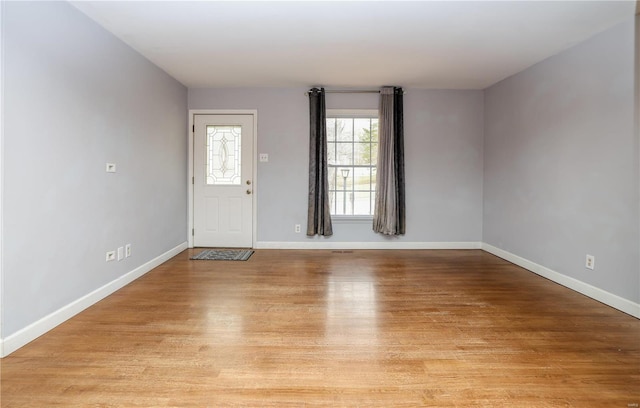 entrance foyer with light wood-style flooring and baseboards