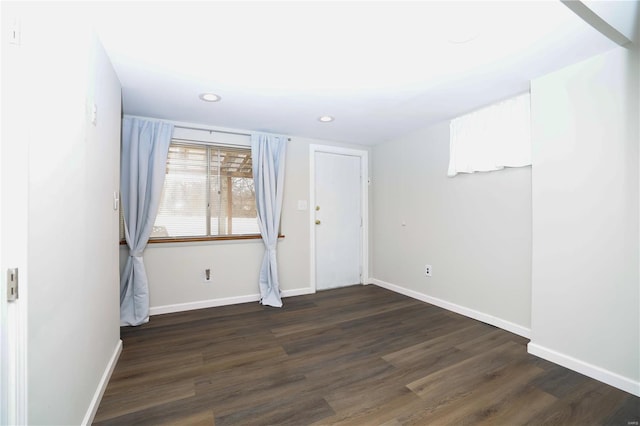 unfurnished room featuring dark wood-type flooring, recessed lighting, and baseboards