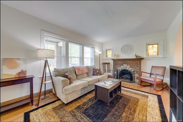 living room with light wood-type flooring and a fireplace