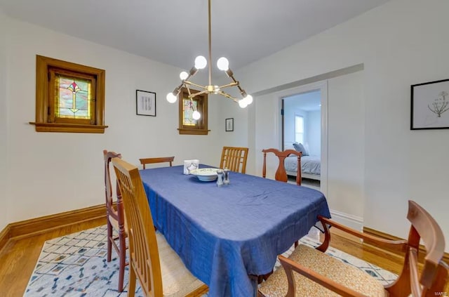 dining room featuring hardwood / wood-style flooring and an inviting chandelier