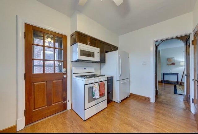 kitchen featuring light wood-type flooring, dark brown cabinetry, white appliances, and ceiling fan