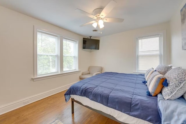 bedroom featuring hardwood / wood-style flooring and ceiling fan