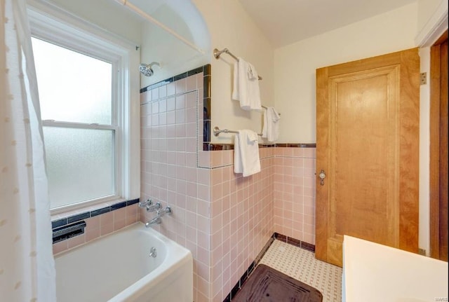 bathroom featuring plus walk in shower and tile walls