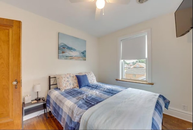 bedroom featuring ceiling fan and dark hardwood / wood-style floors