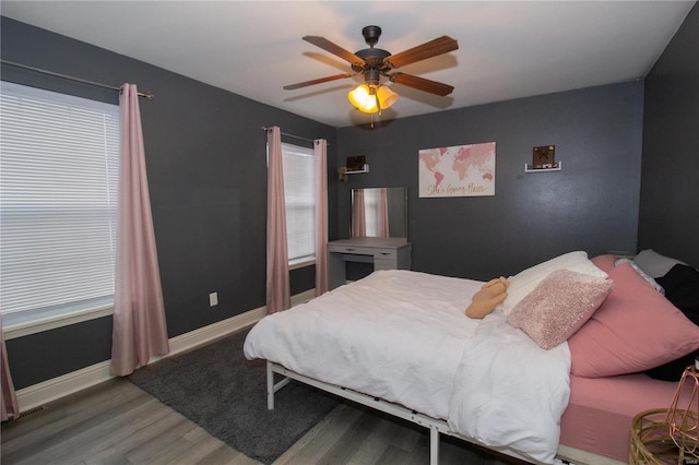 bedroom with ceiling fan and wood-type flooring