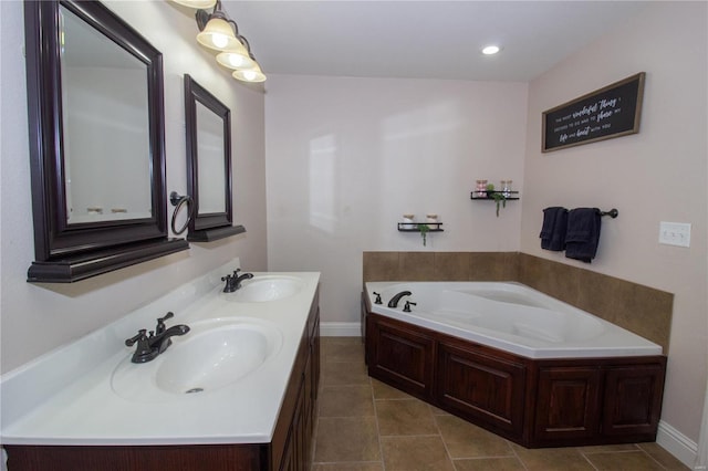 bathroom featuring a bathtub, vanity, and tile patterned flooring