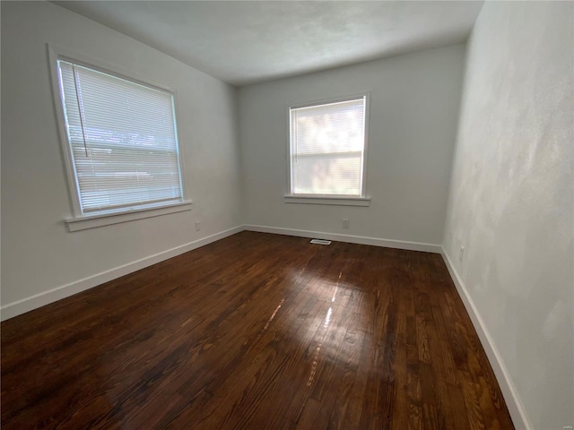 unfurnished room featuring dark hardwood / wood-style floors