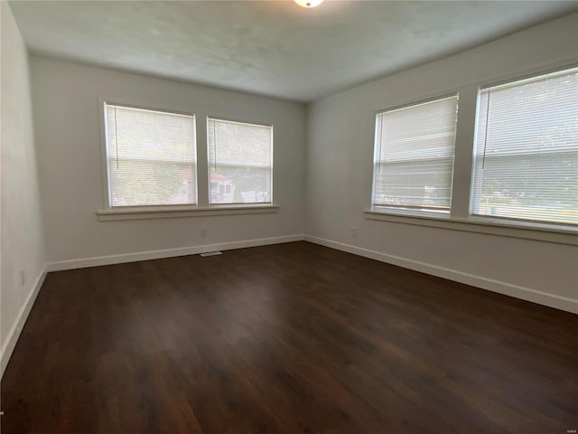 spare room with dark hardwood / wood-style floors