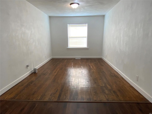 empty room featuring dark hardwood / wood-style flooring