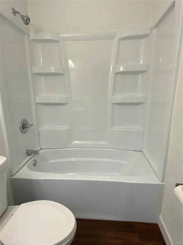 bathroom featuring hardwood / wood-style flooring, toilet, and shower / bath combination