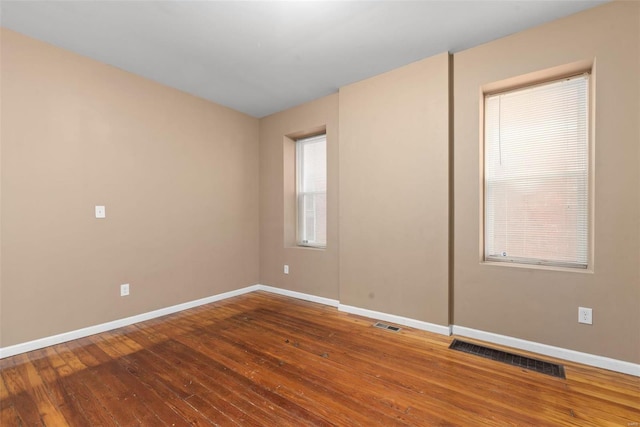 unfurnished room featuring hardwood / wood-style flooring