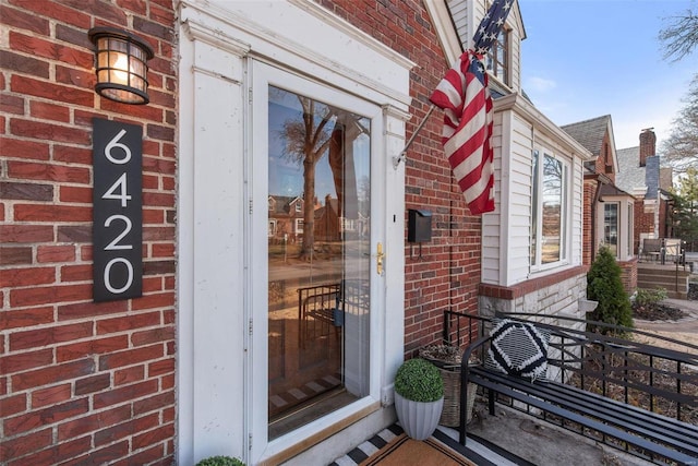 view of exterior entry with brick siding