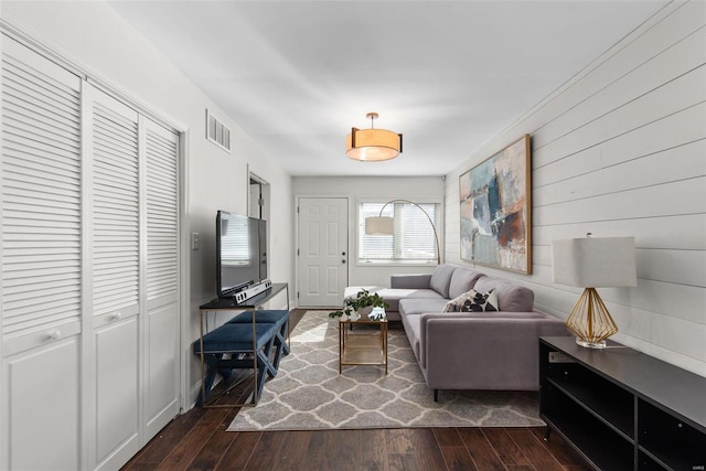 living room featuring dark wood-style floors and visible vents