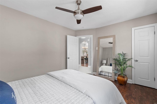 bedroom with baseboards, dark wood-style flooring, and ceiling fan