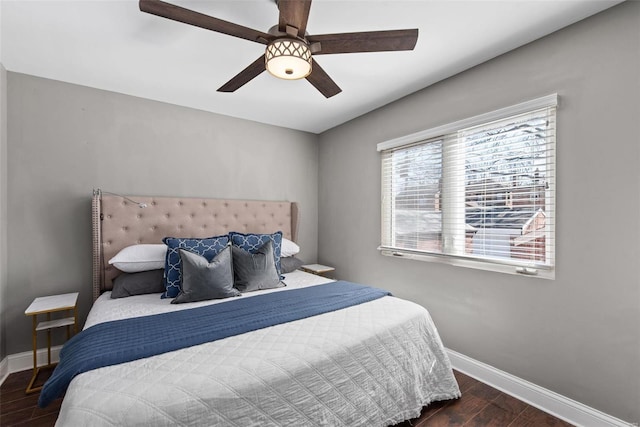 bedroom featuring a ceiling fan, wood finished floors, and baseboards