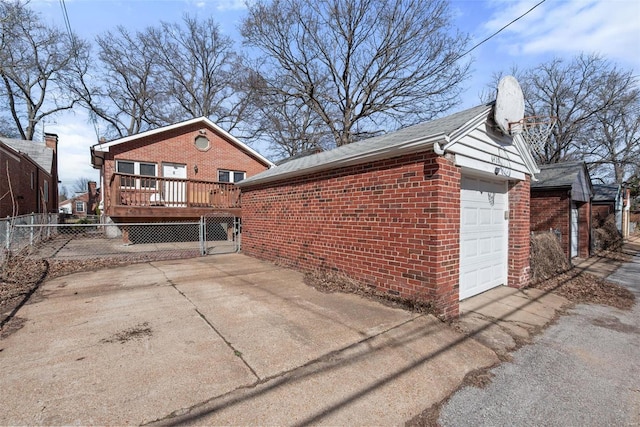 view of side of property featuring brick siding, fence, a wooden deck, a chimney, and driveway