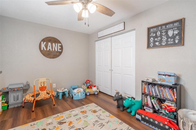 playroom featuring ceiling fan and dark hardwood / wood-style flooring