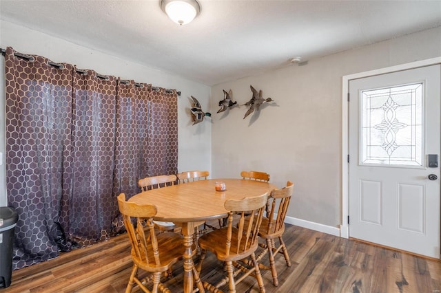 dining space with hardwood / wood-style flooring