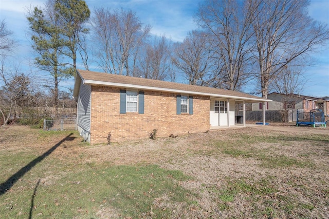 back of house with a lawn