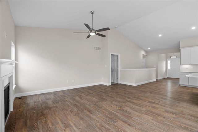 unfurnished living room with high vaulted ceiling, hardwood / wood-style floors, and ceiling fan