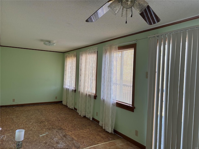 empty room with crown molding, ceiling fan, and a textured ceiling