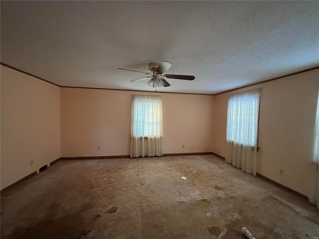 spare room with ceiling fan, ornamental molding, a textured ceiling, and a wealth of natural light