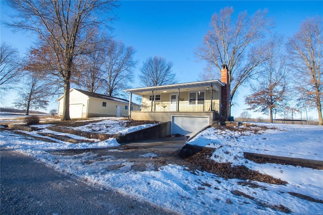 view of front of property with a porch and a garage