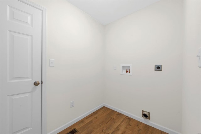 laundry room with washer hookup, hookup for an electric dryer, wood finished floors, laundry area, and baseboards