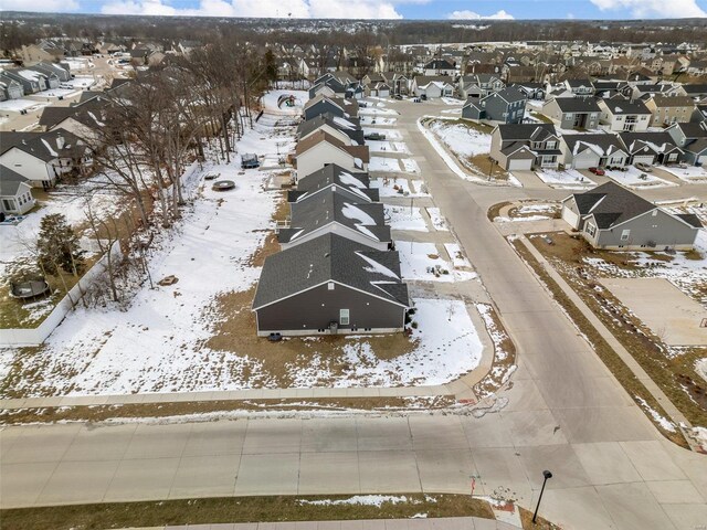 snowy aerial view featuring a residential view