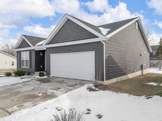 ranch-style house featuring a garage and driveway