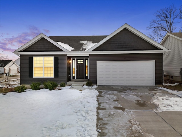 view of front of property featuring concrete driveway and an attached garage